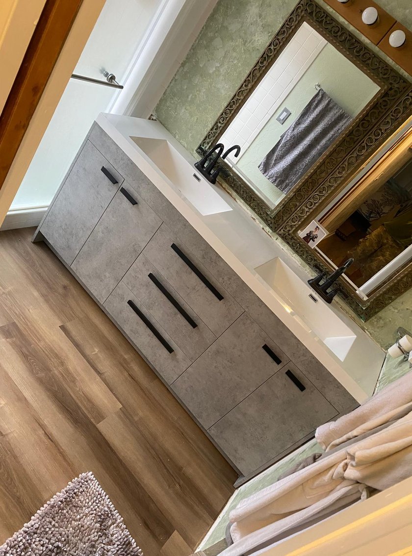 Bathroom vanity with white quartz top, undermount sink, matte black faucet, and a sliding barn-door cabinet front